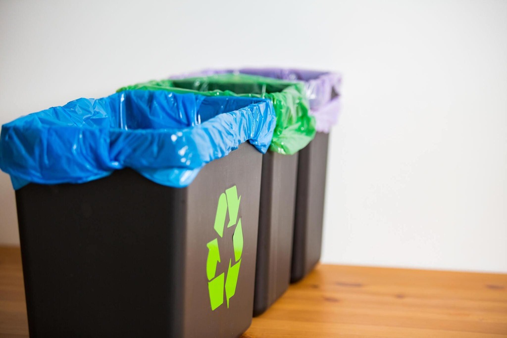 Three trash bins with sorted garbage